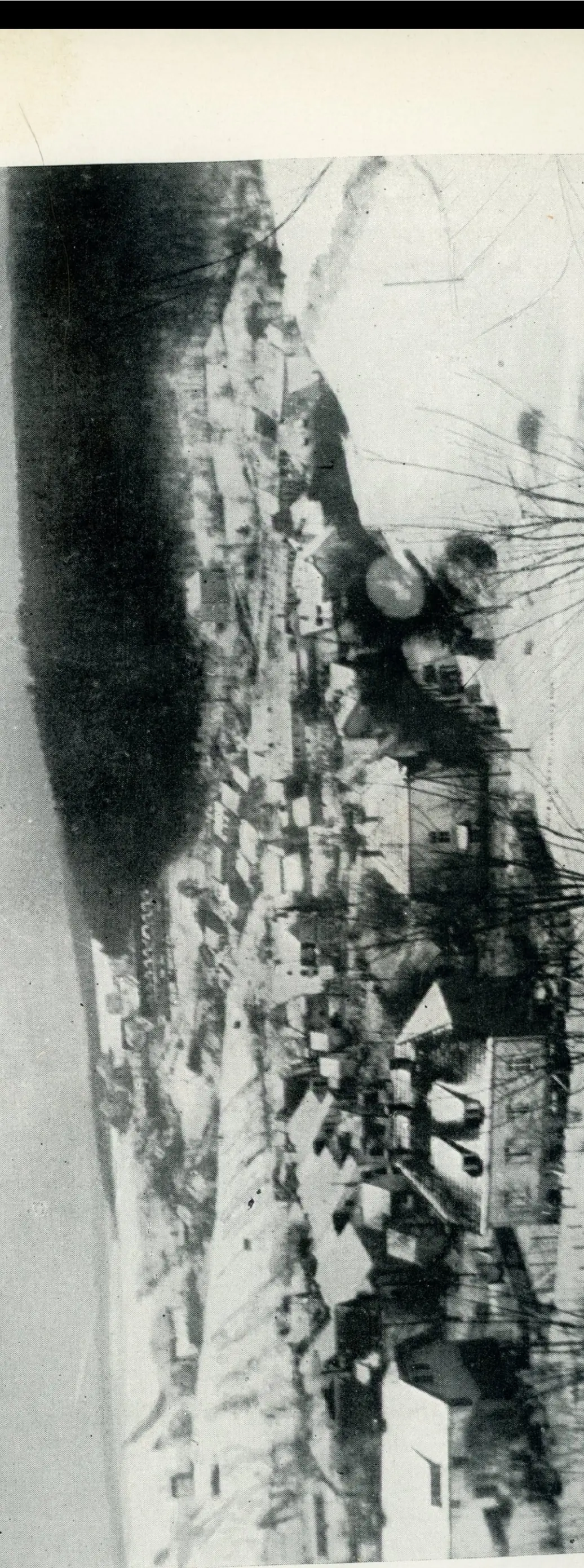 A snow-covered view of the town of Ludweiler under a bleak winter sky